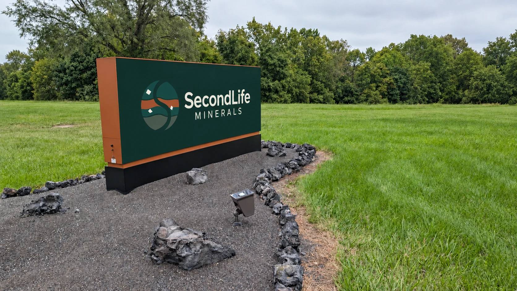 Entrance-bed concept with rough gray mineral rocks and a green-and-copper SecondLife logo sign with plain ends.